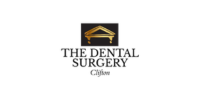 Logo for "The Dental Surgery Clifton" featuring a gold stylised building pediment above the business name in black text on a white background.